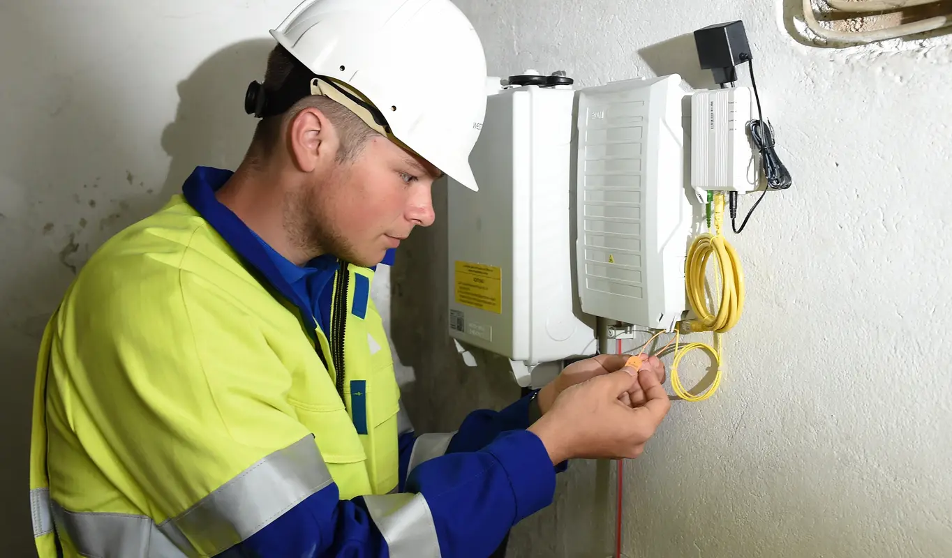 Mitarbeiter arbeitet am Glasfaserabschlusspunkt.